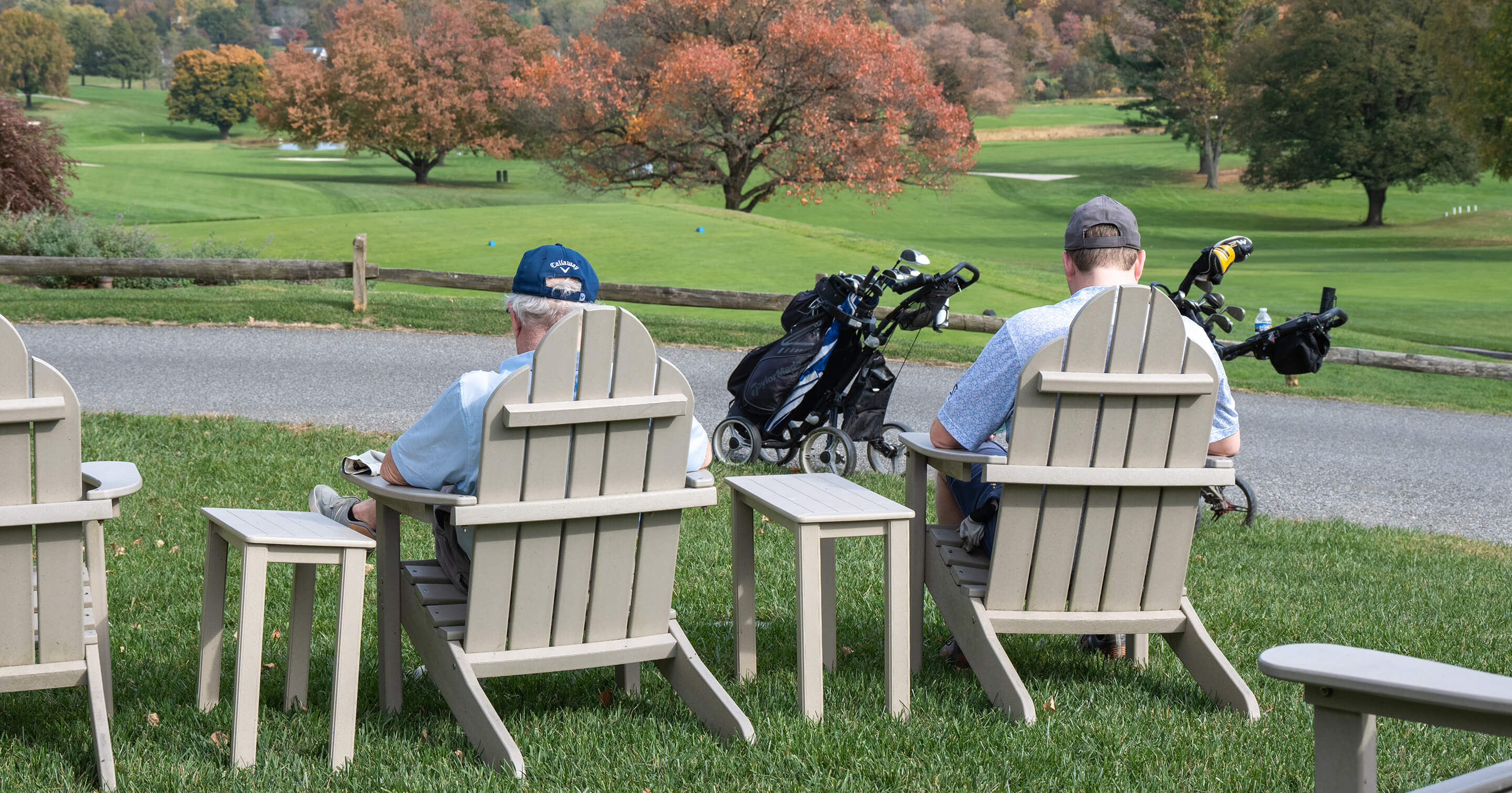 golfers relaxing in Adirondack chairs